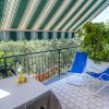 Terrazza con sedie blu e pianta.