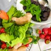 Verdure e frutta, come carote, sedano, fragole e prugne in ciotole.