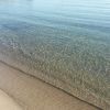 Spiaggia con sabbia fine e mare limpido.