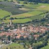 Un villaggio con tetti arancioni in una valle verde.