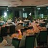 Un ristorante elegante con tavoli apparecchiati e candele accese.