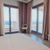 Camera con letto, tende e vista mare.