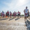 Persone che corrono sulla spiaggia vicino all'acqua.